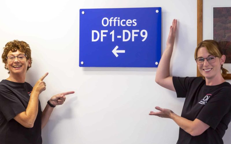Jaxckie & Heather Funny Face Pointing at Offices Sign 1 (1)
